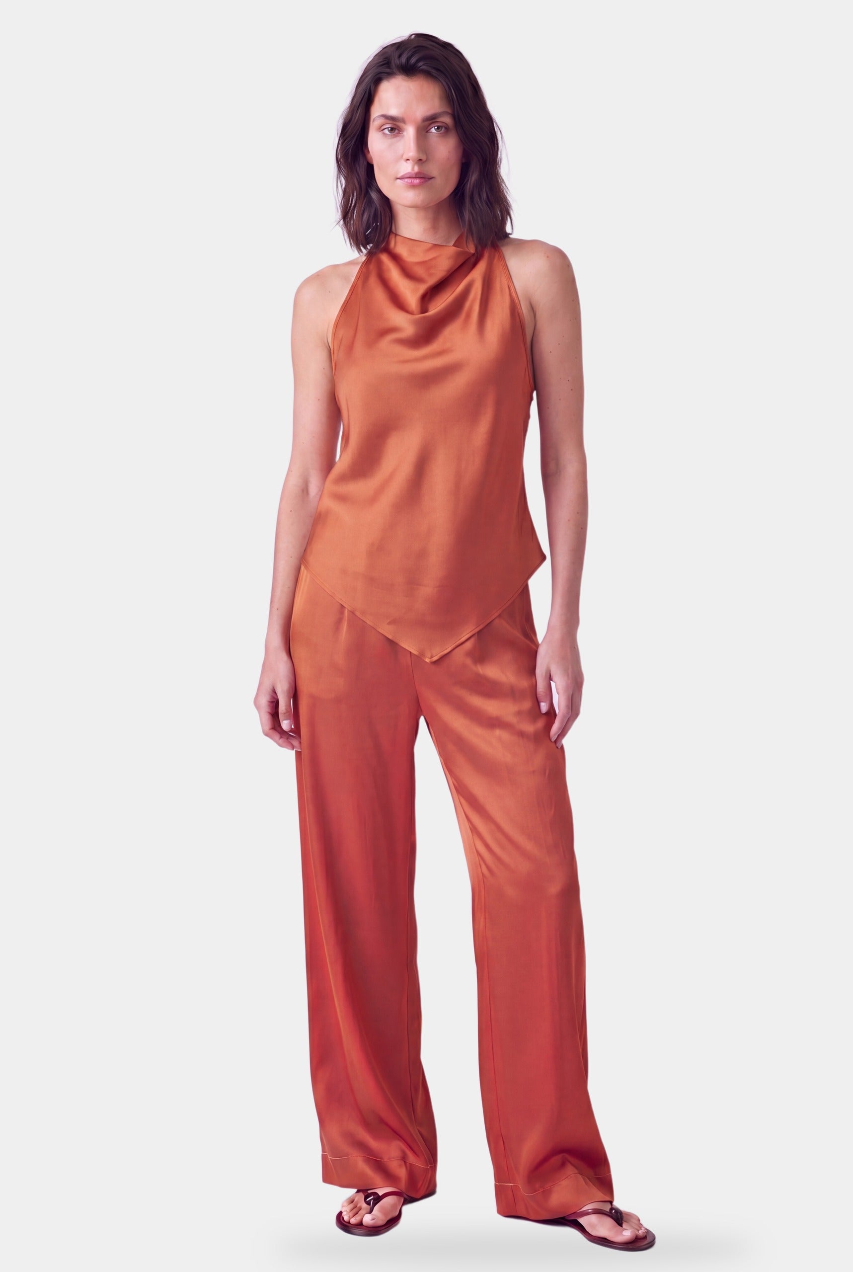 Woman in Amber silk halter top and trousers, front, NOKAYA The Lady
