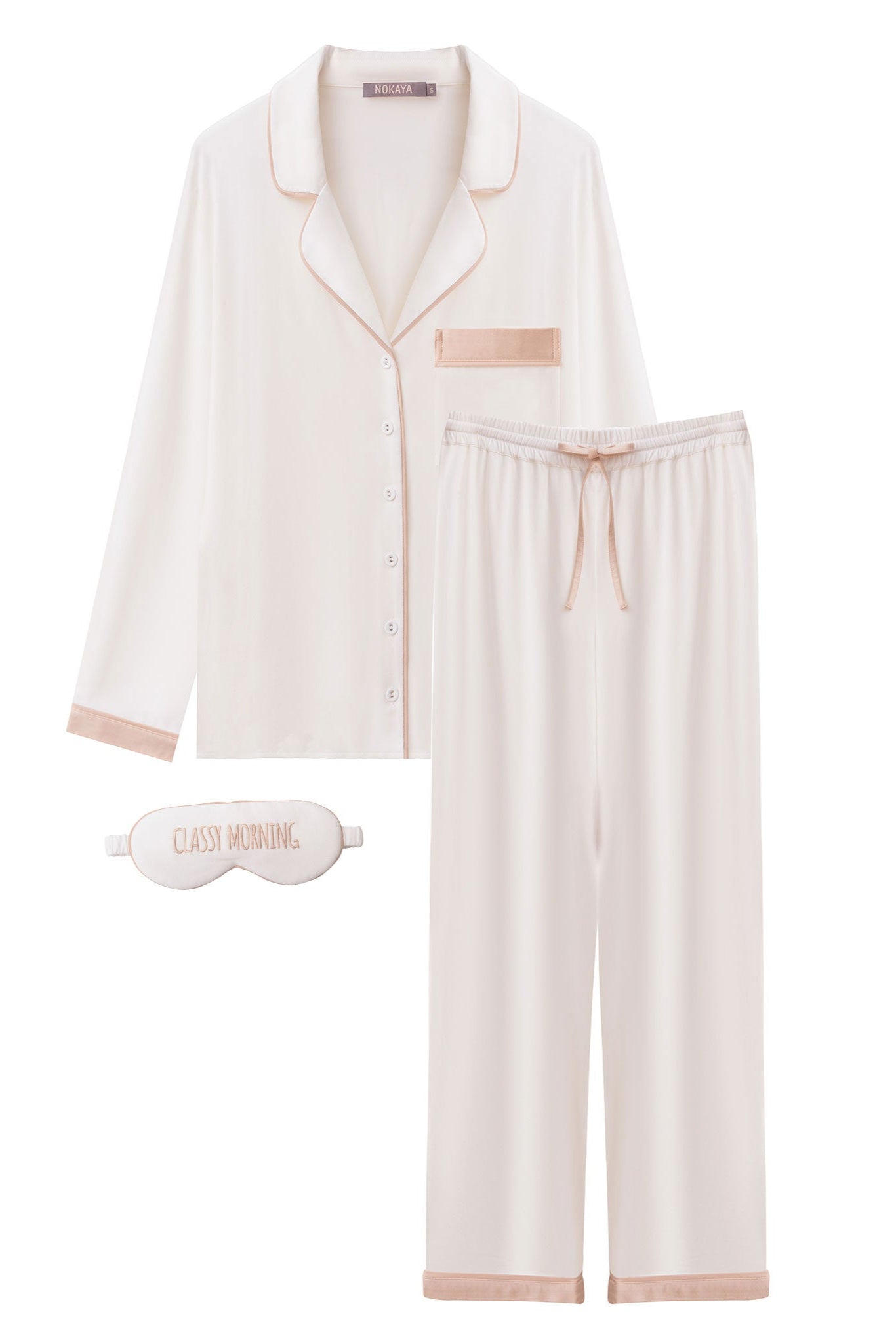White pajama set with pink trim and matching sleep mask on a white background