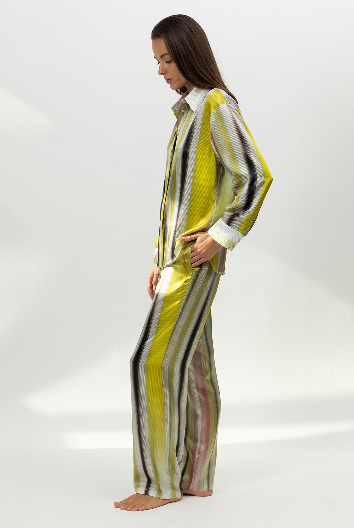 Person wearing a silk yellow and black striped outfit Nokaya on a white background