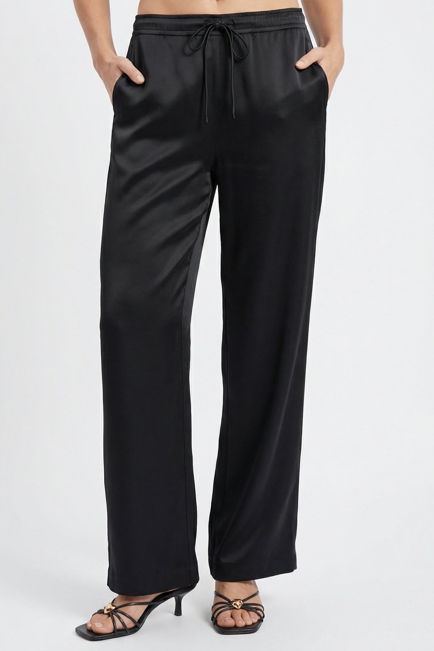 Black Silk pants Nokaya, worn by a person on a white background& Front view.
