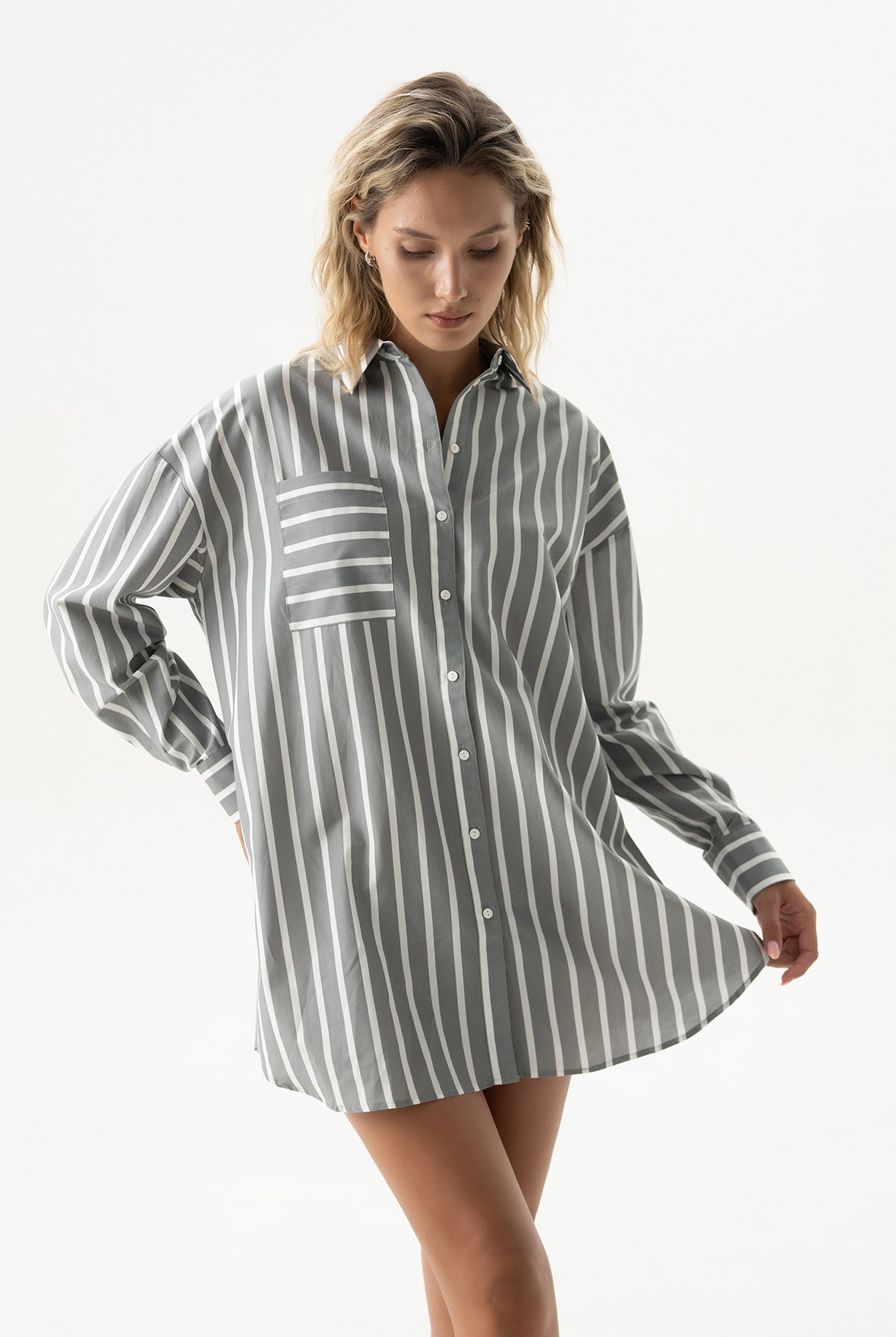 Woman wearing a striped shirt dress on a white background