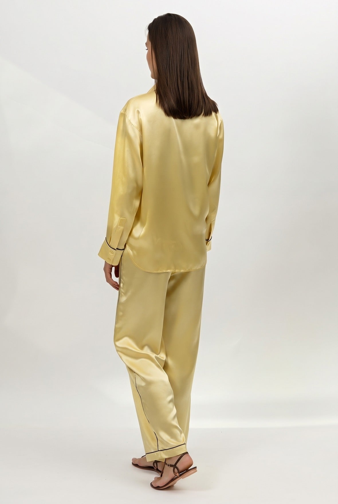 Gold silk satin pyjama set Nokaya on a white background. Back view.