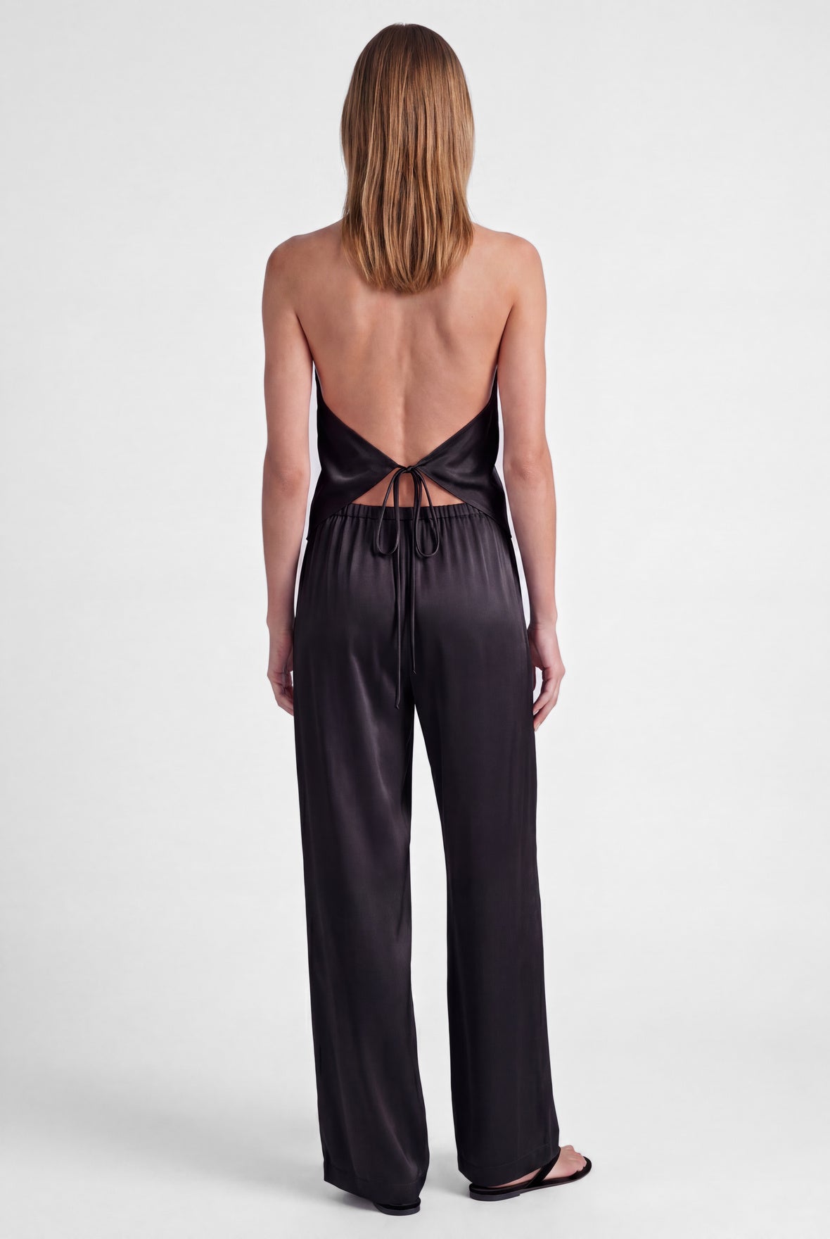 Black silk halter top The Lady, full-length back view with trousers and sandals