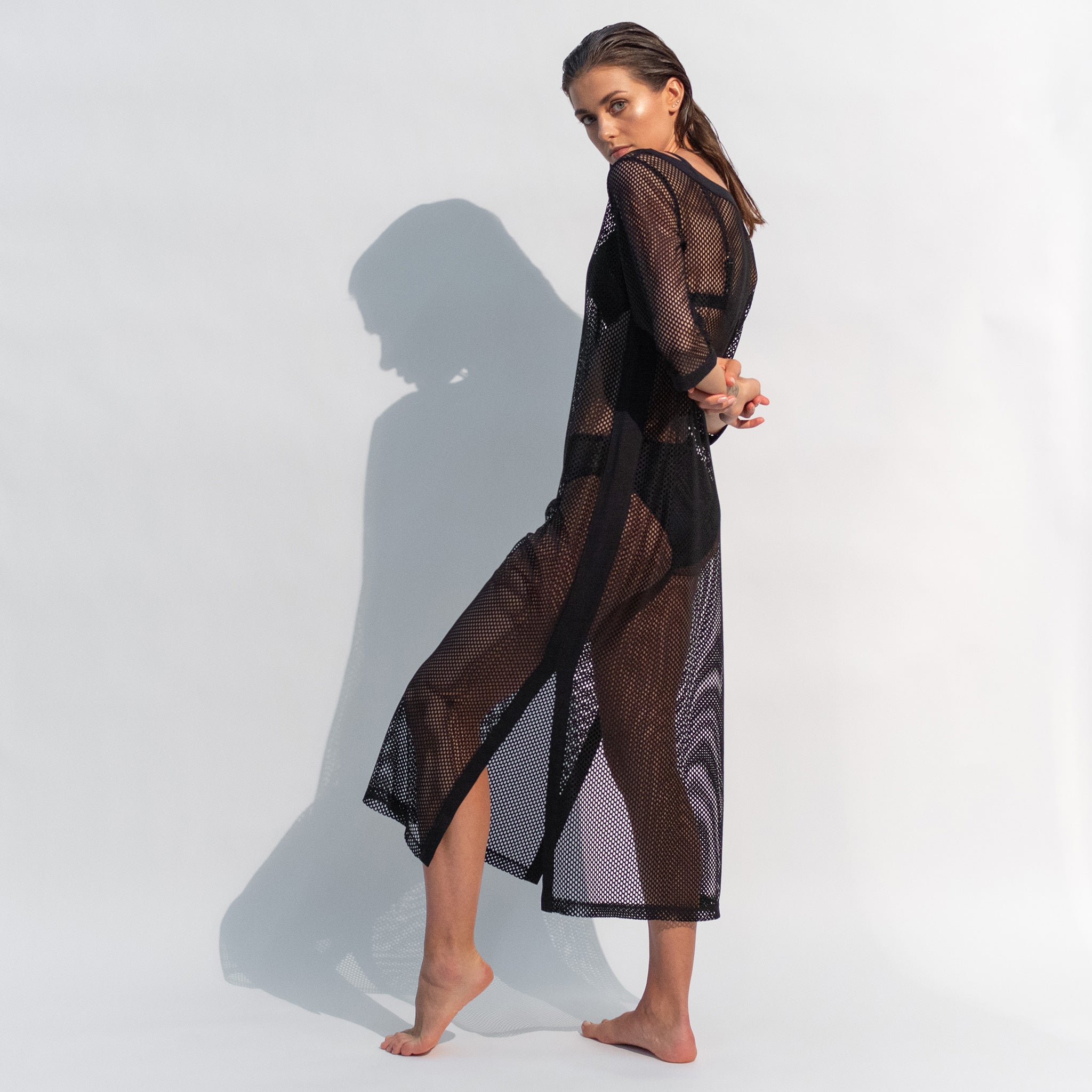 Stylish Daring Net black dress is perfect for layering over a swimsuit.