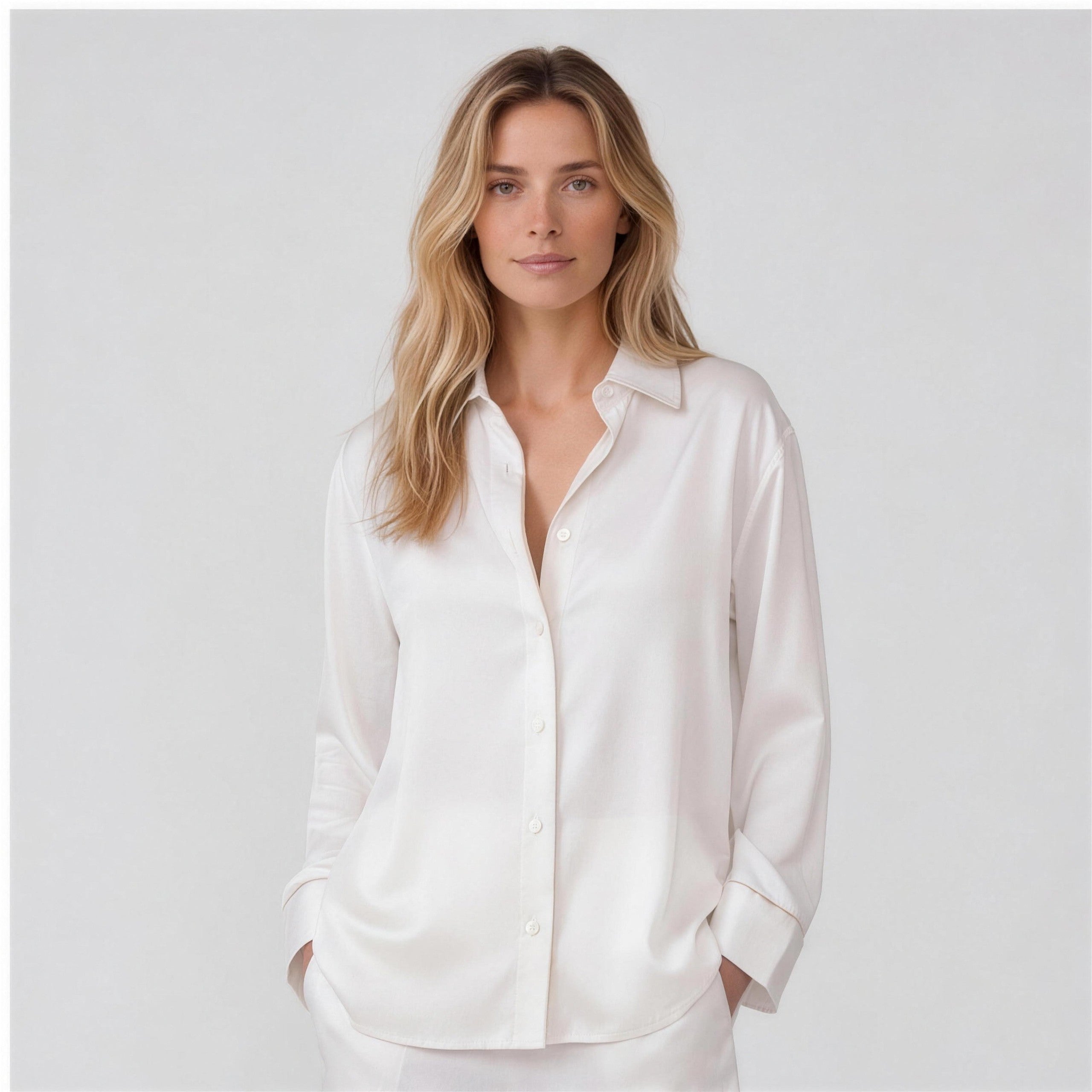 Ivory silk shirt three-quarter view with hands in pockets, NOKAYA
