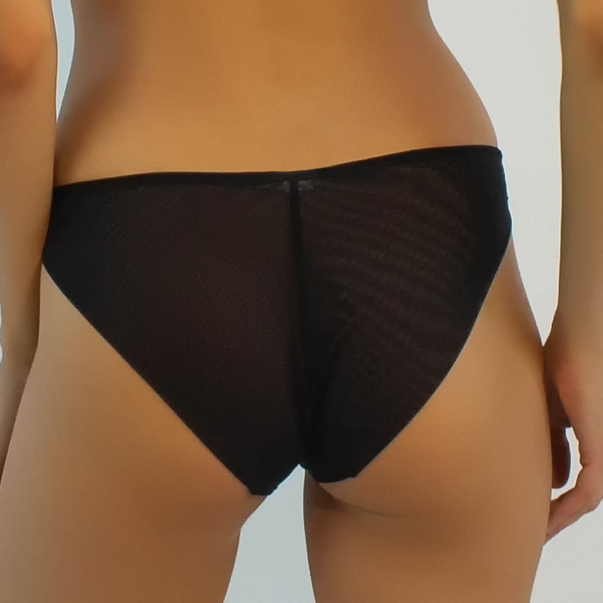 The Crossing Lines black bikini is designed from soft Italian tulle. Back close-up view