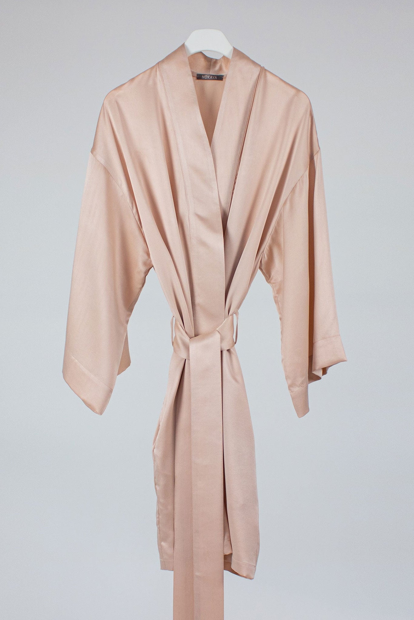 Pink silk robe on hanger