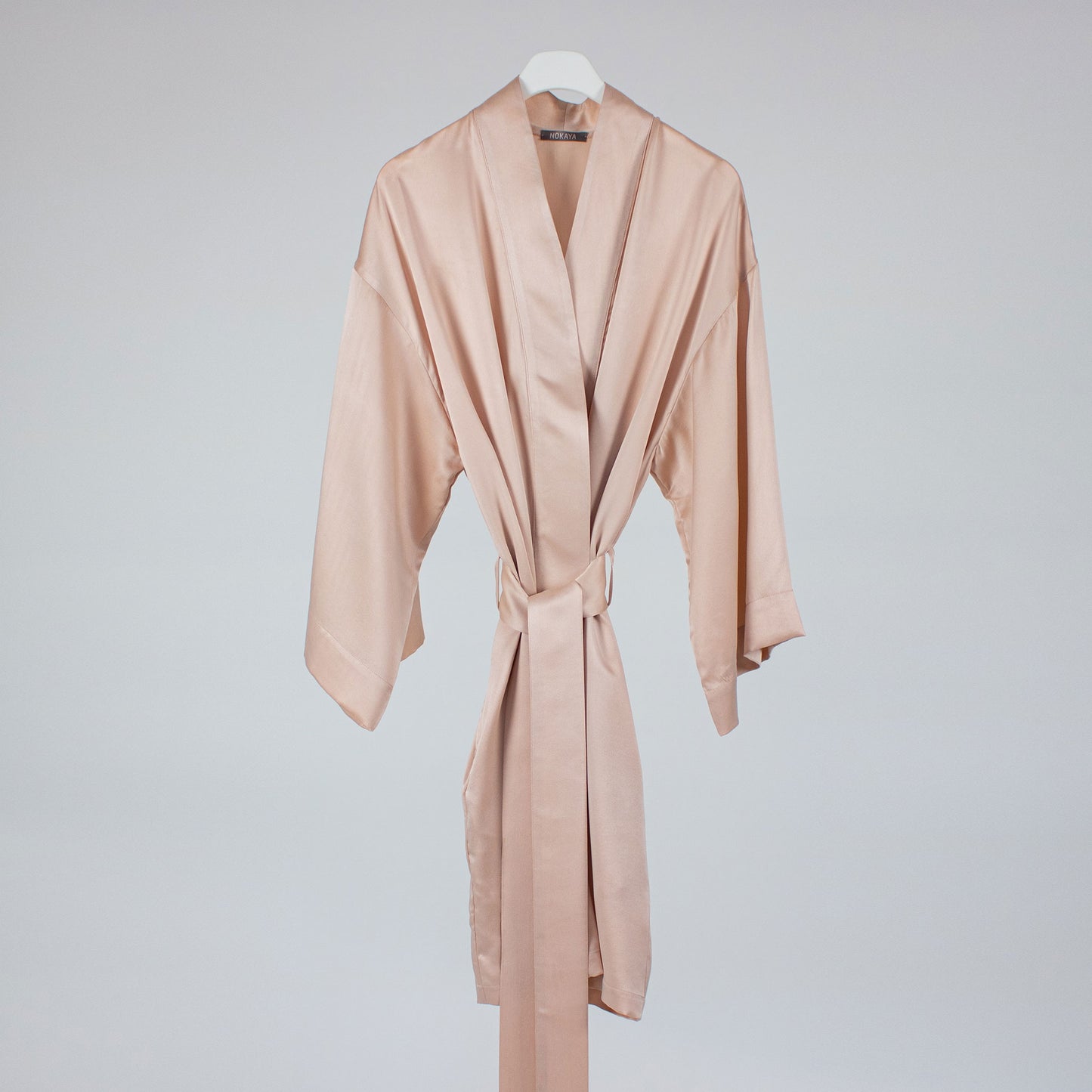 Pink silk robe on hanger