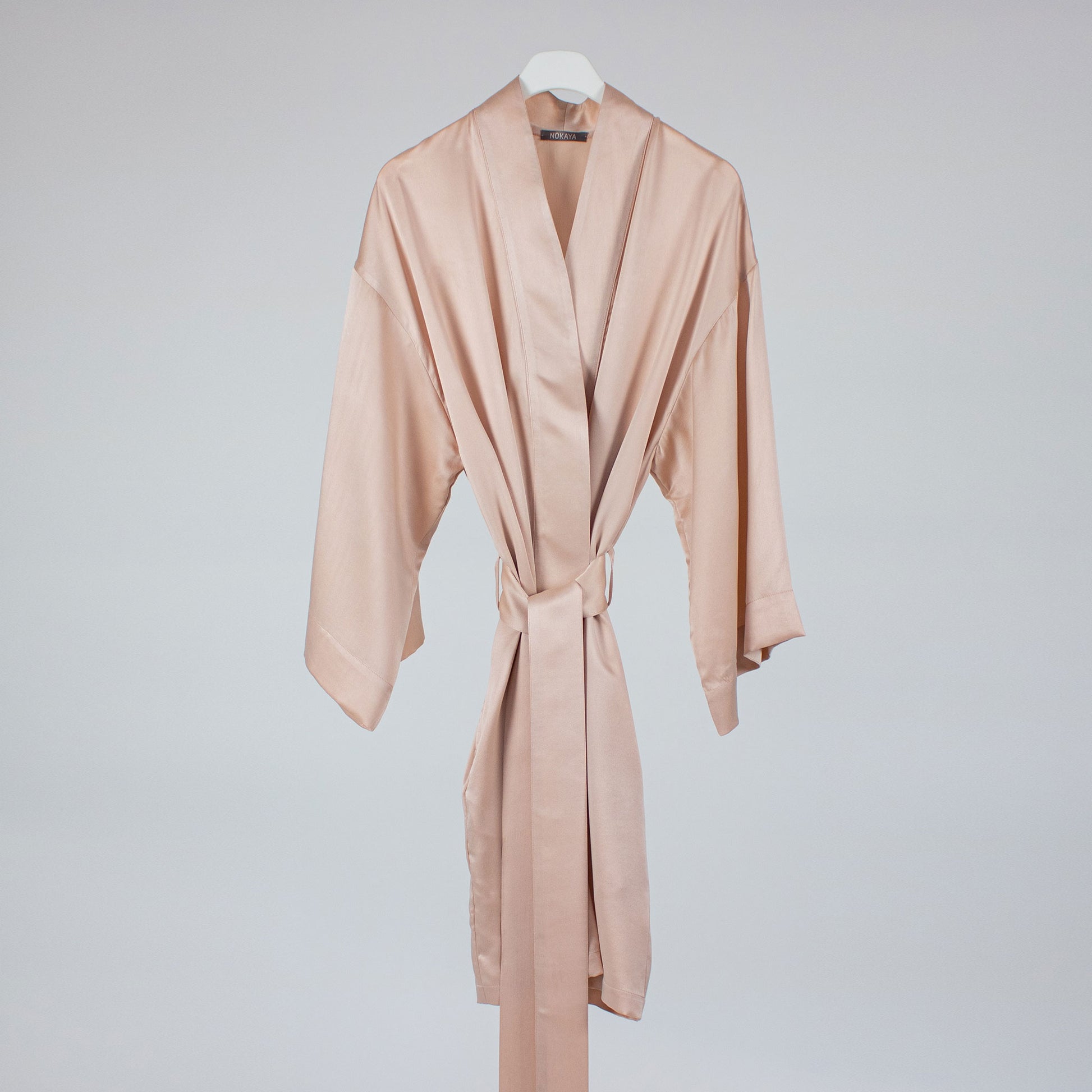 Pink silk robe on hanger