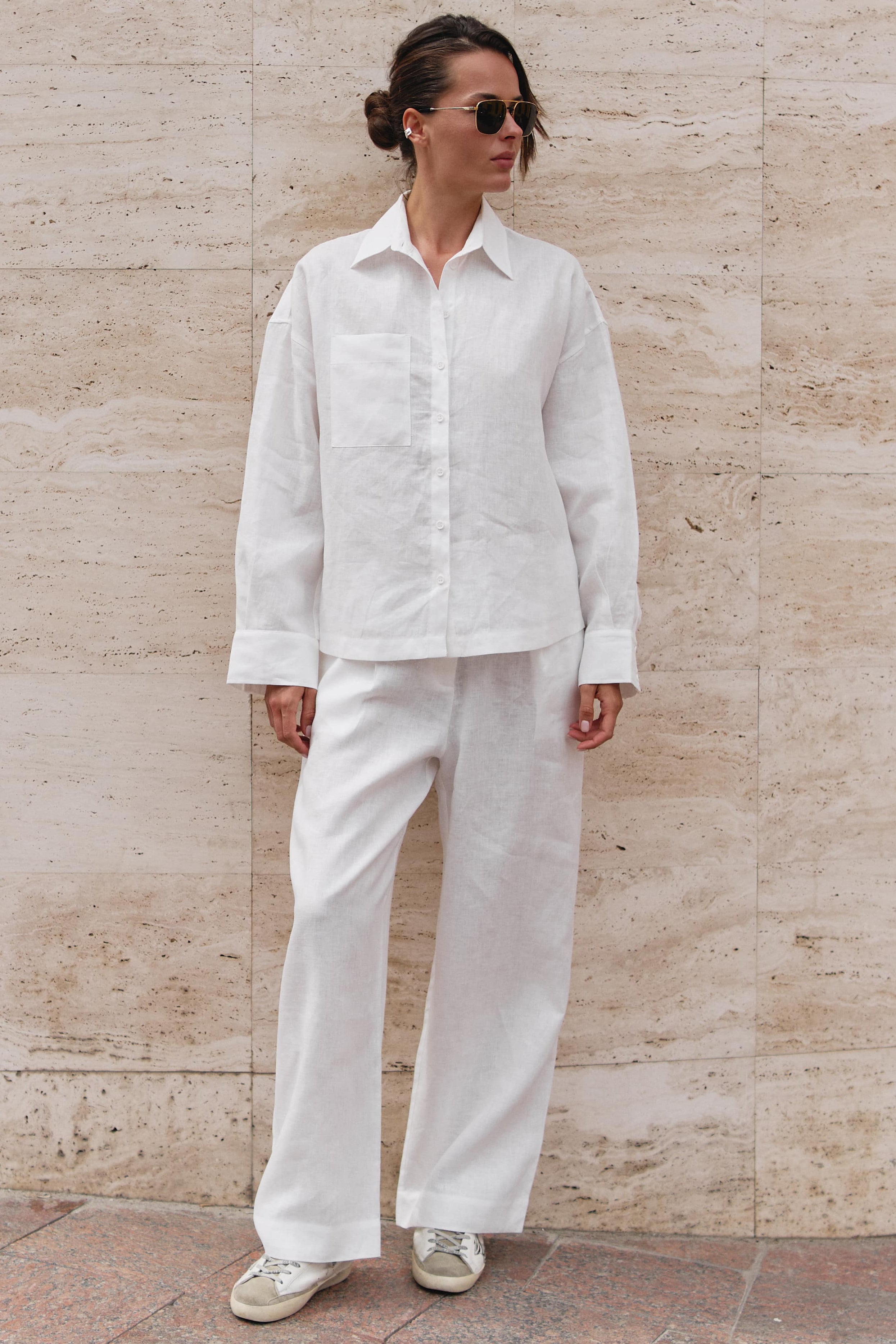 White linen trousers with shirt Nokaya in street style shootings. 