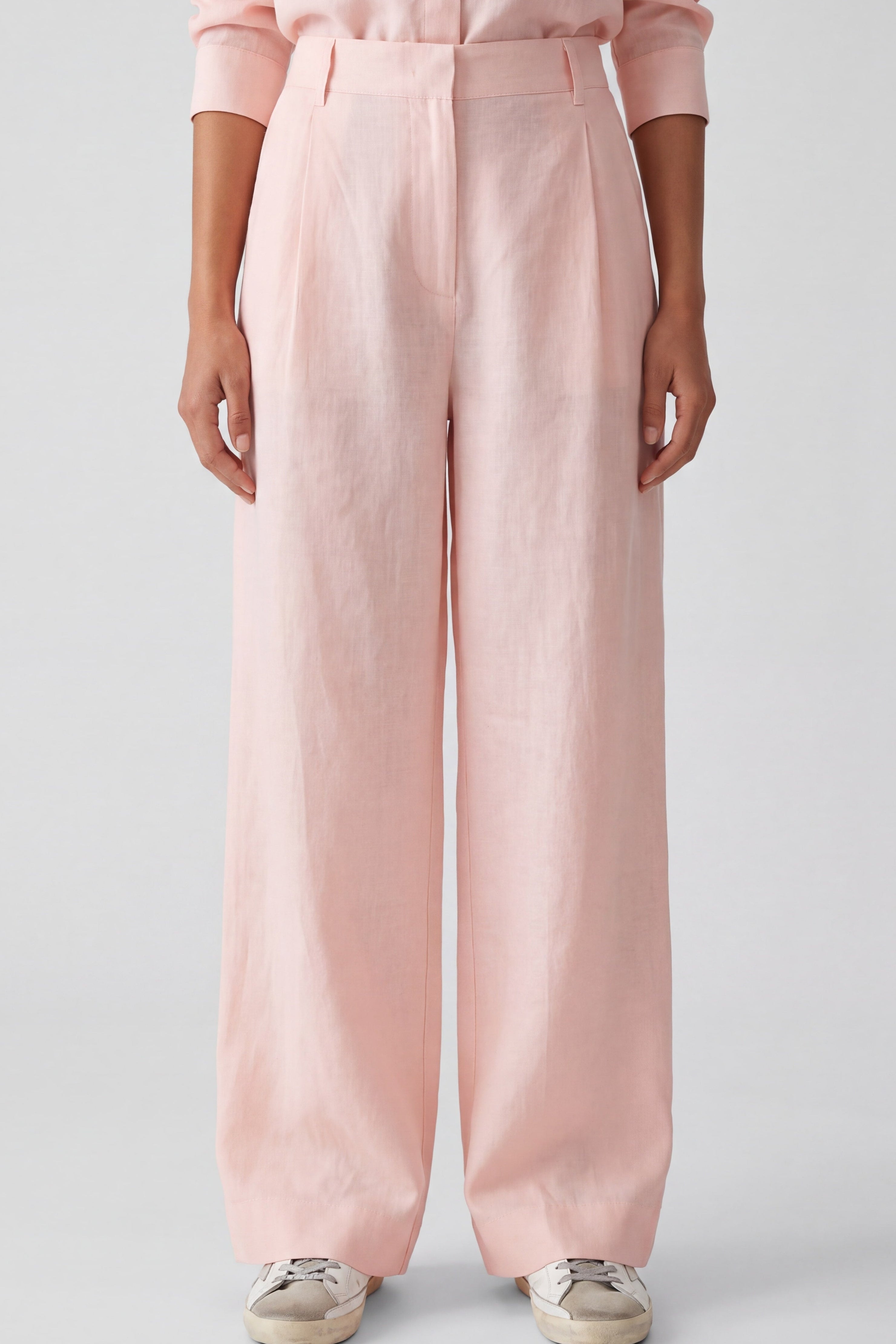 Pink Linen trousers Nokaya on the grey background.