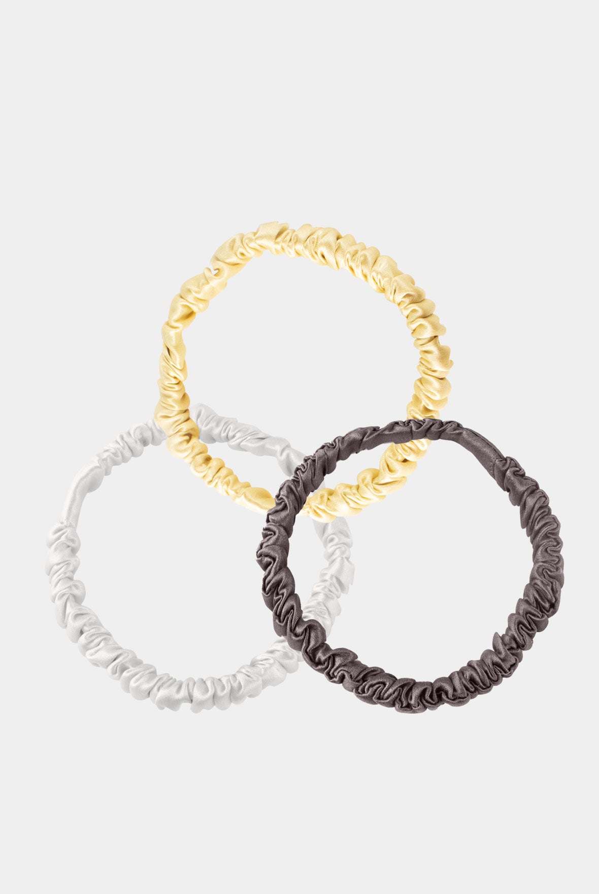 Skinny Silk Scrunchie Set Ivory, Caramel, Future Brown on grey background