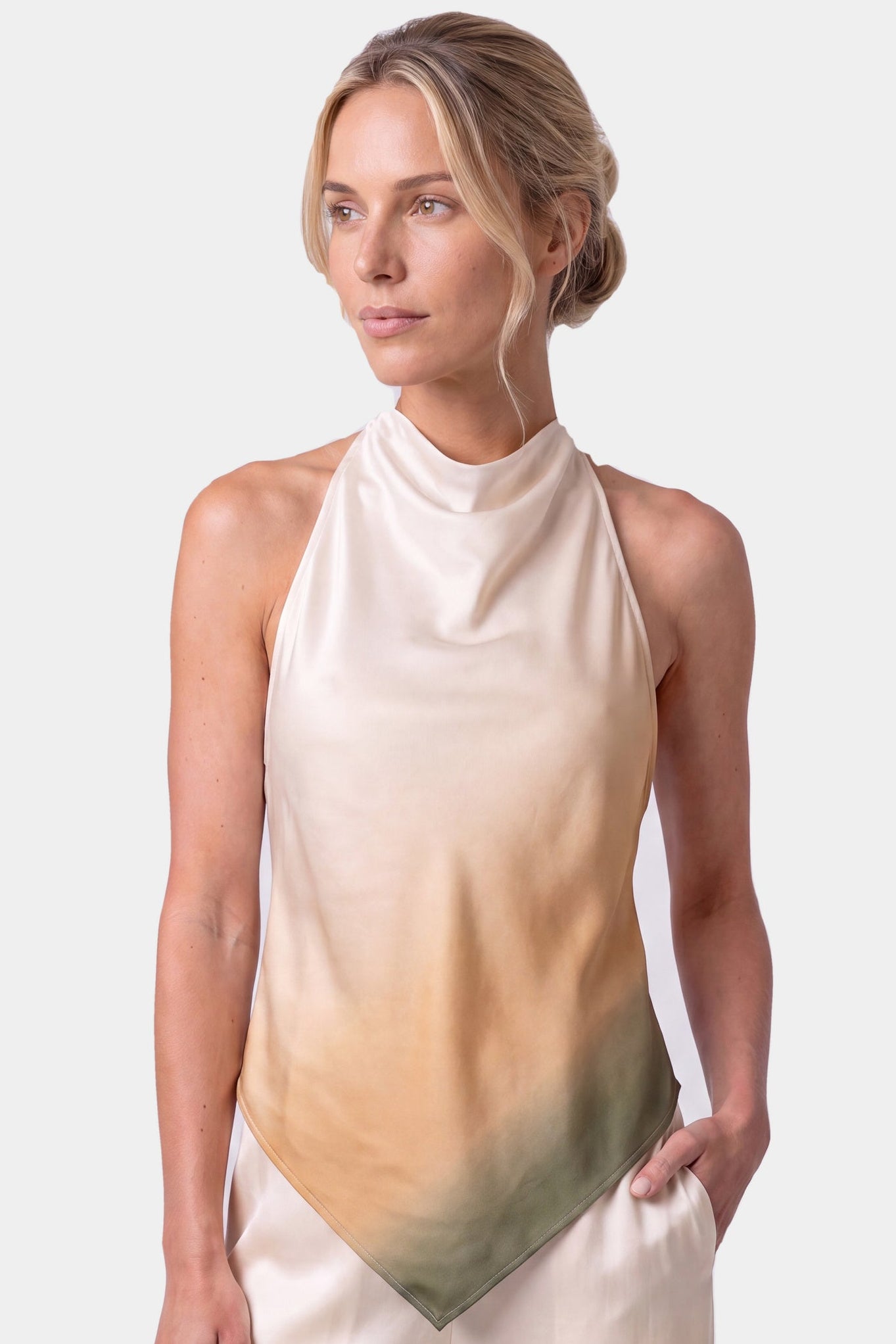 Silk sleeveless halter-neck top Nokaya with a soft gradient colour transition from cream to beige and olive green, paired with matching cream pants, against a light grey studio background.