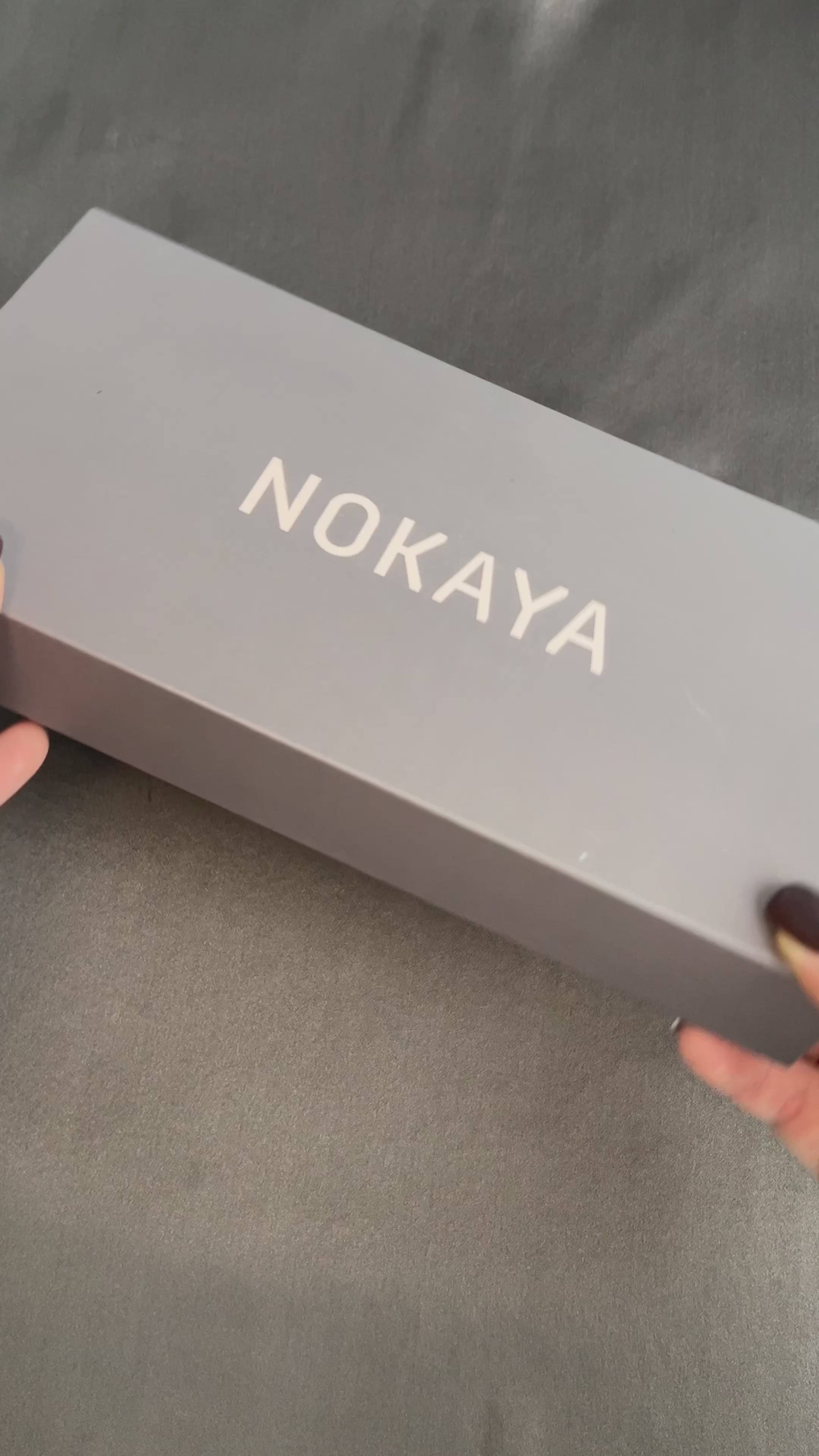 silk eye mask in yellow colour. On the video lady opens gift box with eye mask Nokaya