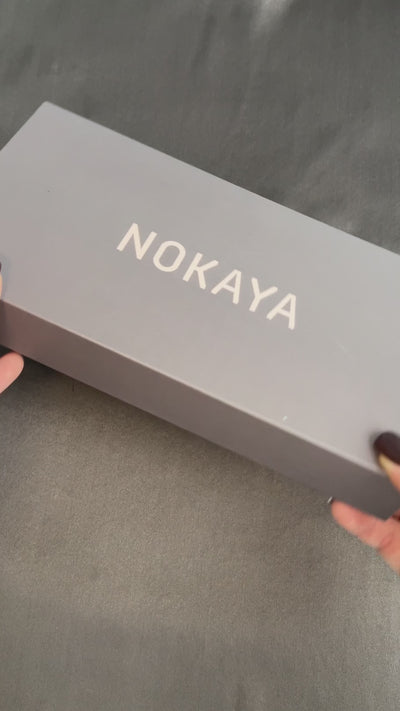 silk eye mask in yellow colour. On the video lady opens gift box with eye mask Nokaya