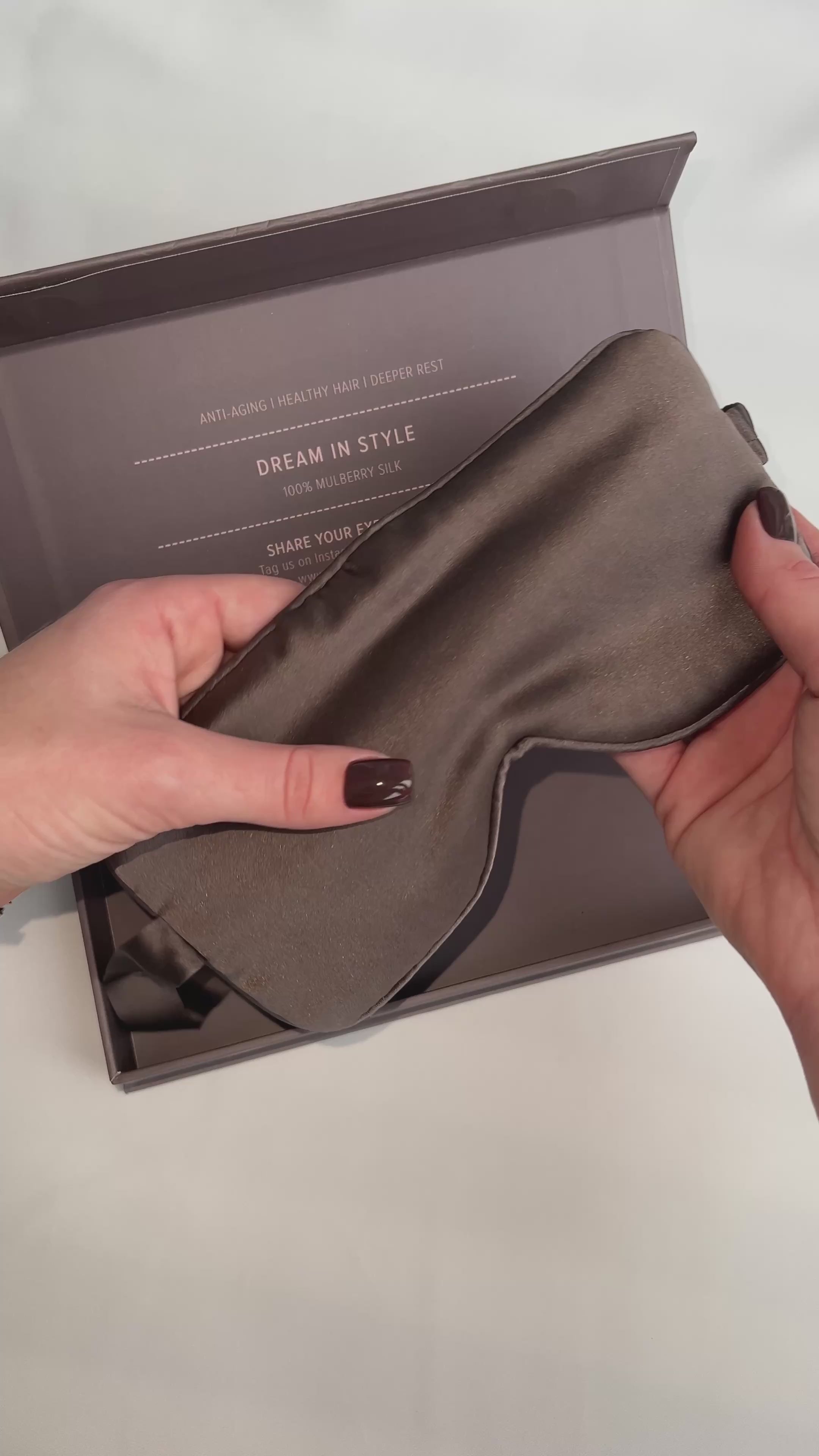 silk eye mask in brown colour. On the video lady open gift box with eye mask Nokaya