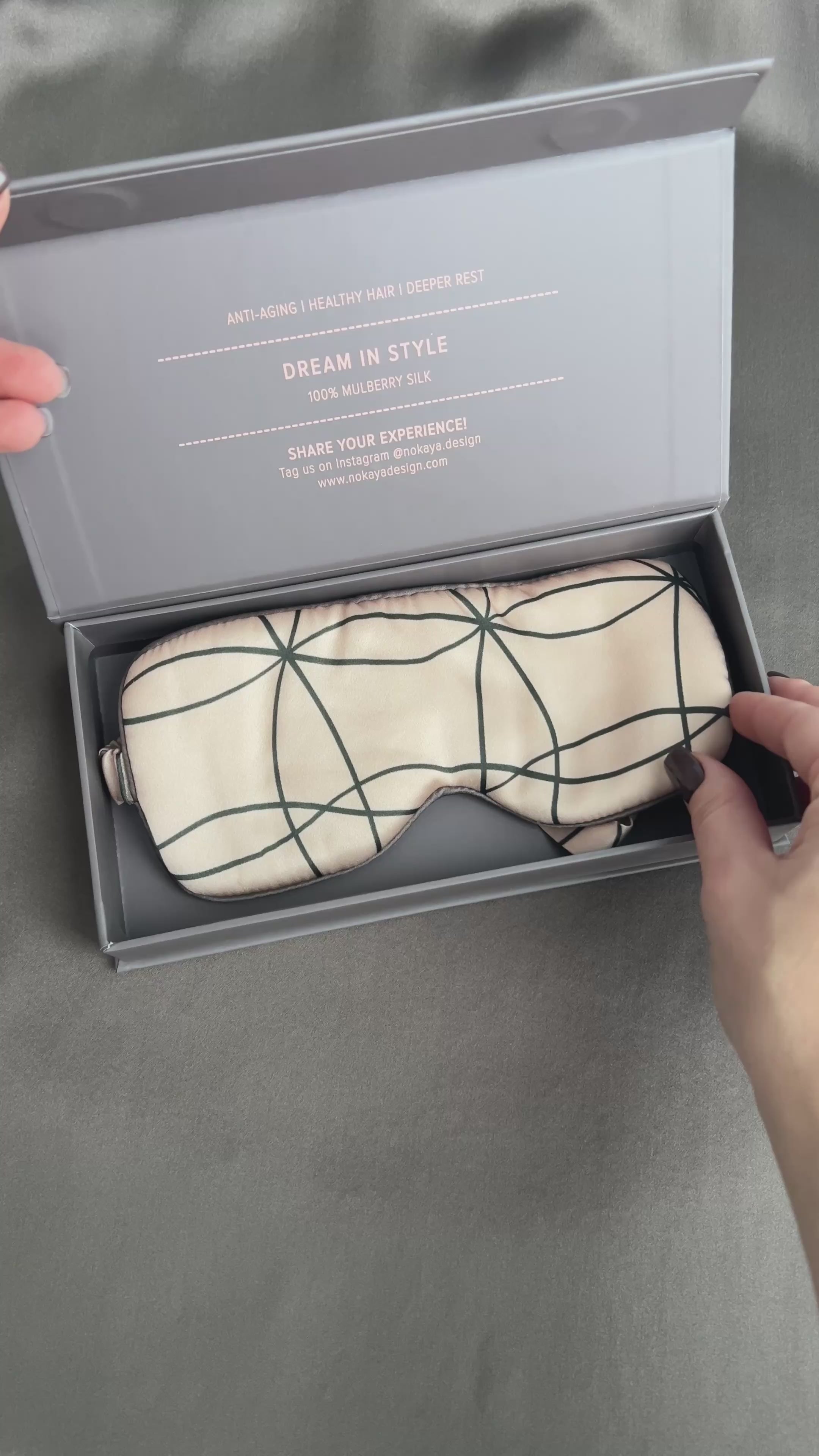 silk eye mask in pink colour. On the video lady open gift box with eye mask 