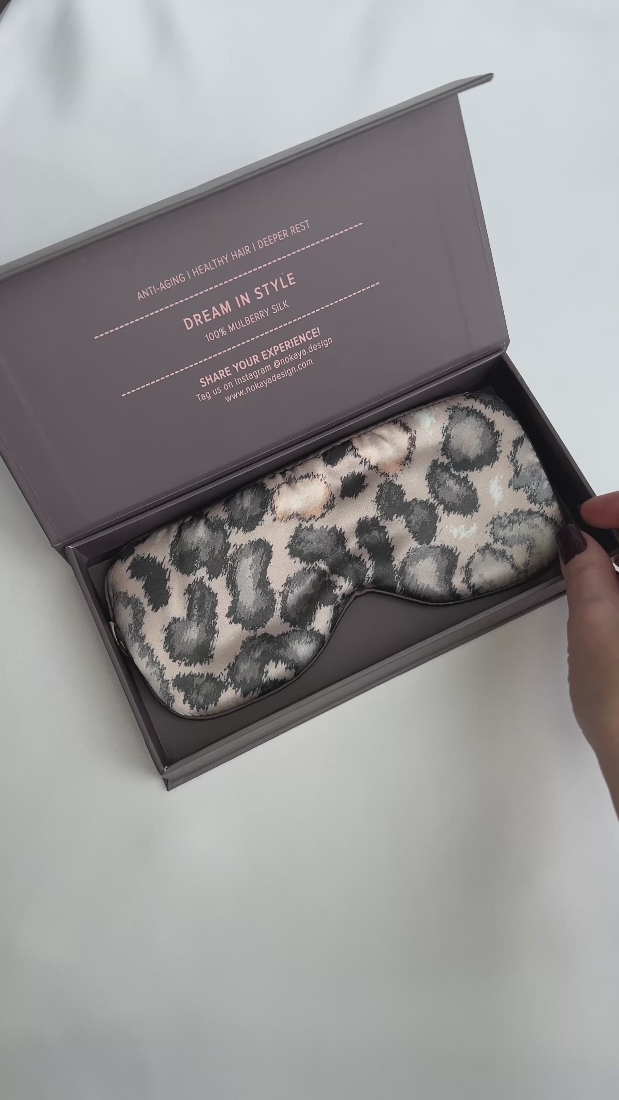 silk eye mask with animal print colour. On the video lady open gift box with eye mask Nokaya