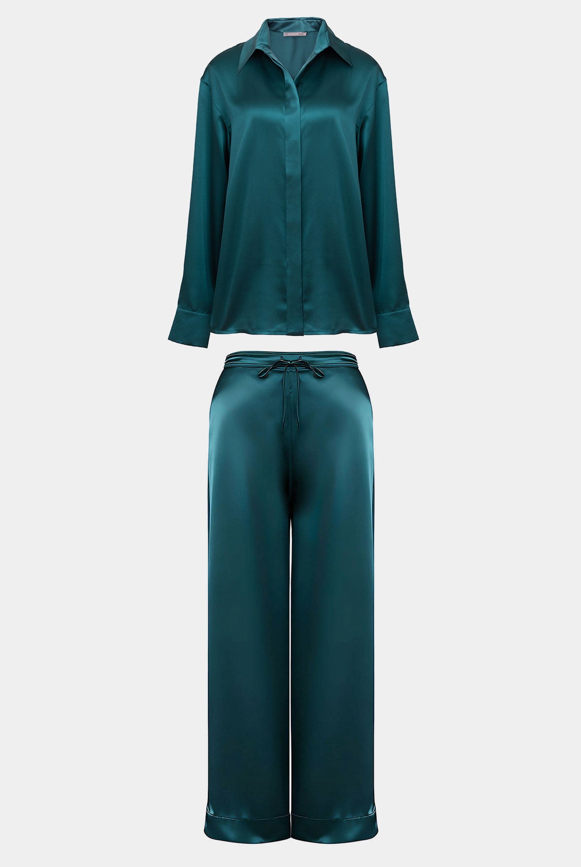 Silk pylamas in colour Teal eclipse. Shirt and pants set on a white background. Nokaya