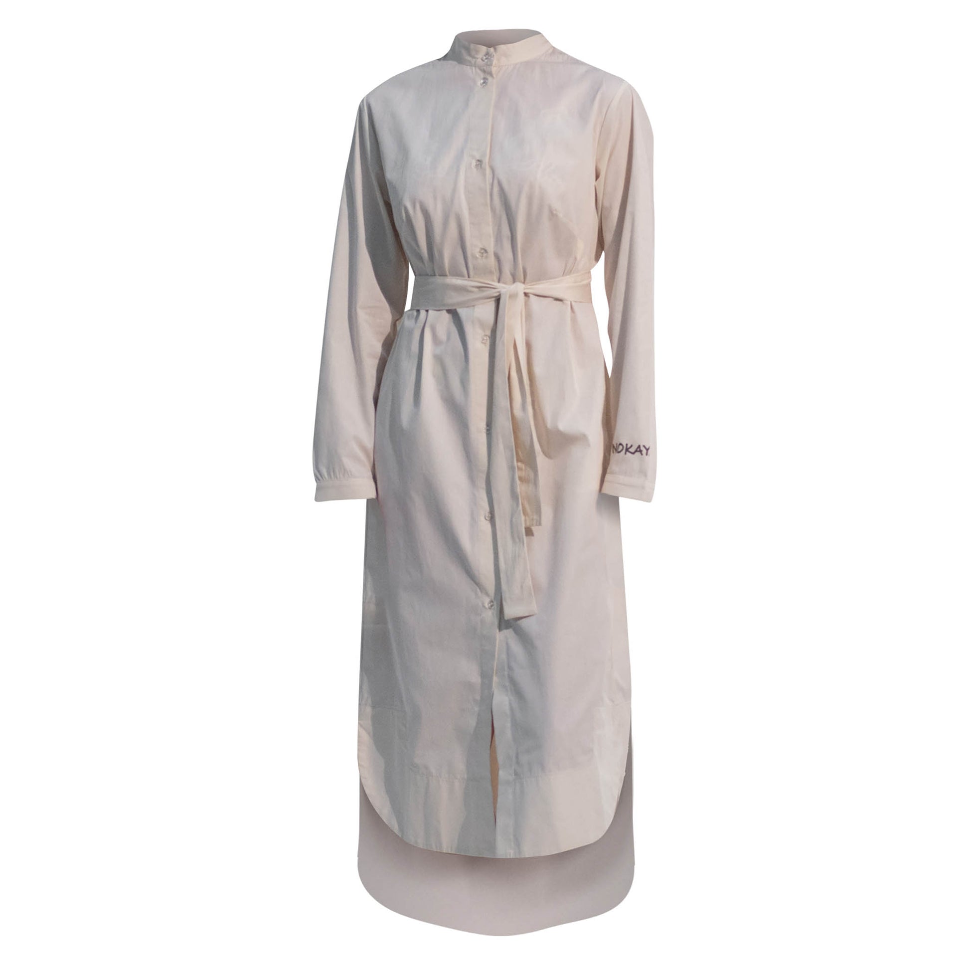 The Inner Matters cotton dress features a stylish, asymmetrical cut with a thin belt accentuating a silhouette.