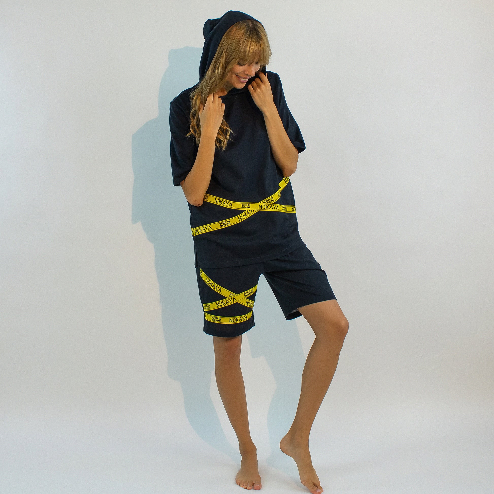 The almost black textured cotton shorts in a relaxing silhouette with the emphasis on yellow stripes with a logo.