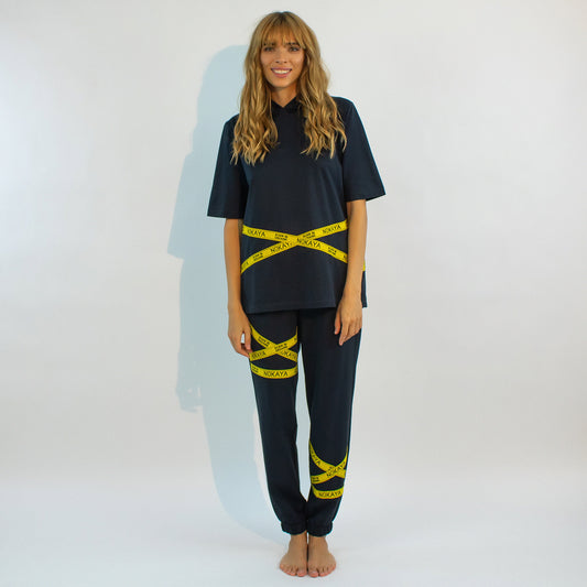 The almost black textured cotton pants in a relaxing silhouette with the emphasis on yellow stripes with a logo.