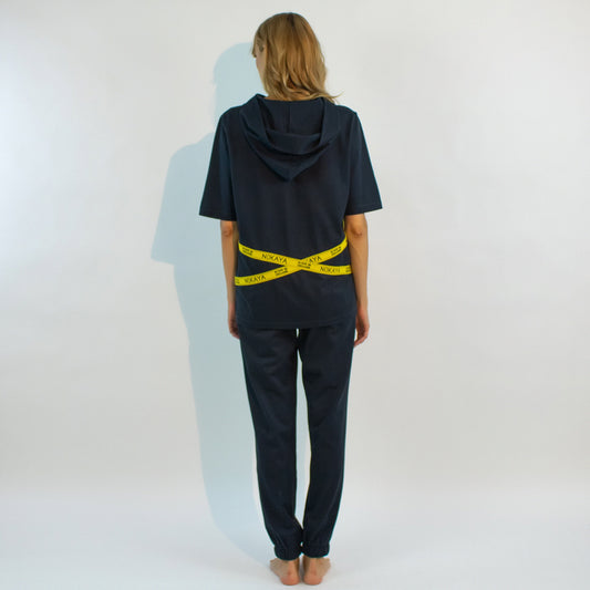 The almost black textured cotton pants in a relaxing silhouette with the emphasis on yellow stripes with a logo.