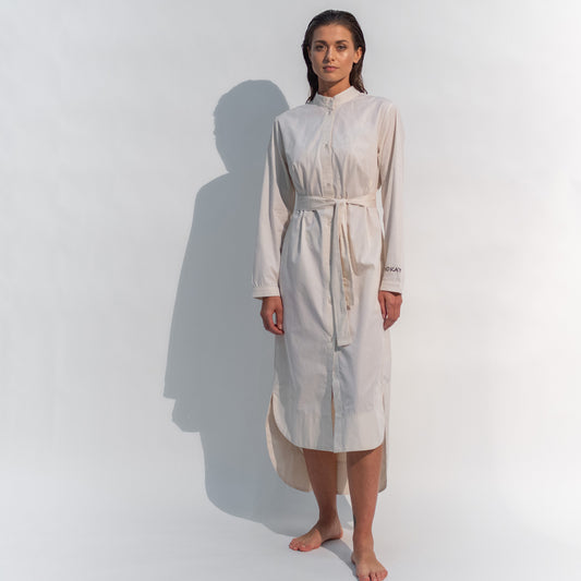 The Inner Matters cotton dress features a stylish, asymmetrical cut with a thin belt accentuating a silhouette.